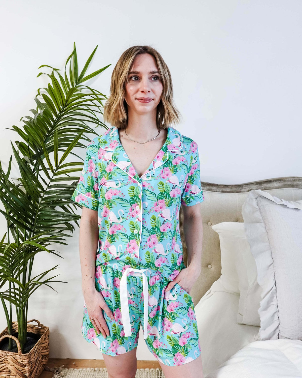 Tropic Like It's Hot Bamboo Short Sleeve Pajama Set worn by a model, featuring pink flamingos and tropical orchids.