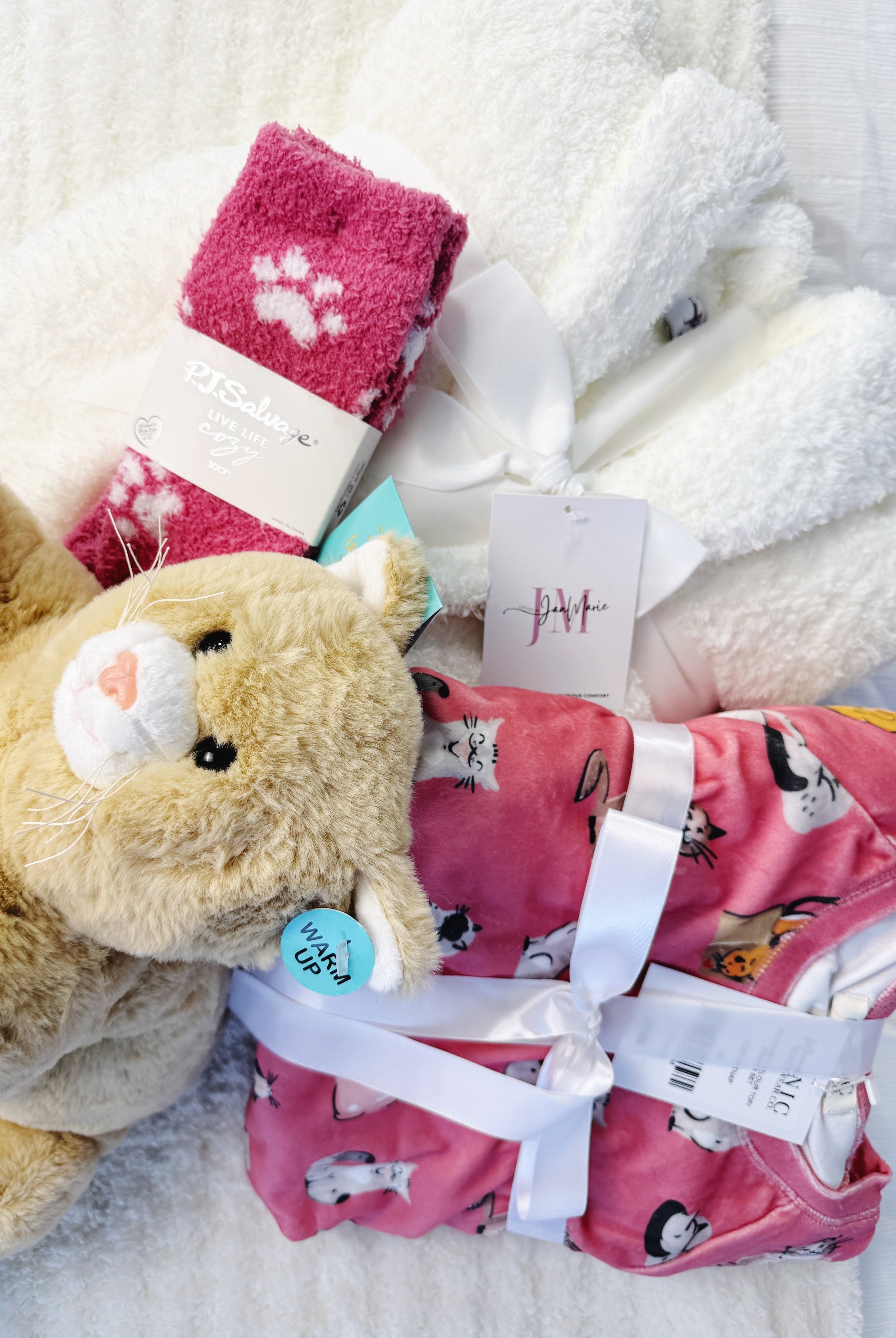 the Ultimate Cat Lover Gift Set, completley ready to wrap for anyone who loves kittys. Cat Print Pajamas, A plush white rove, socks and and a heating cat plush complete the gift set!