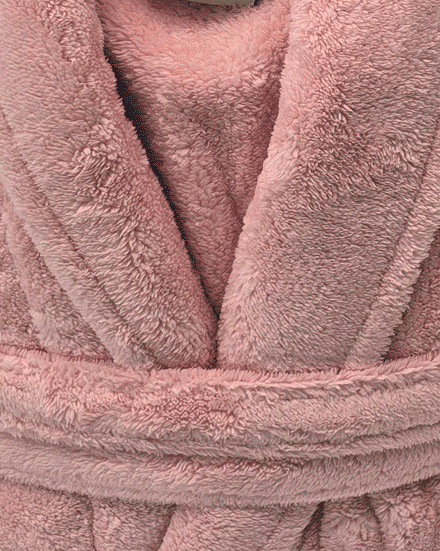 Close-up of a pink plush robe with texture details from warm buddy