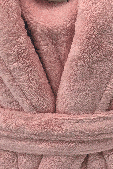Close-up of a pink plush robe with texture details from warm buddy