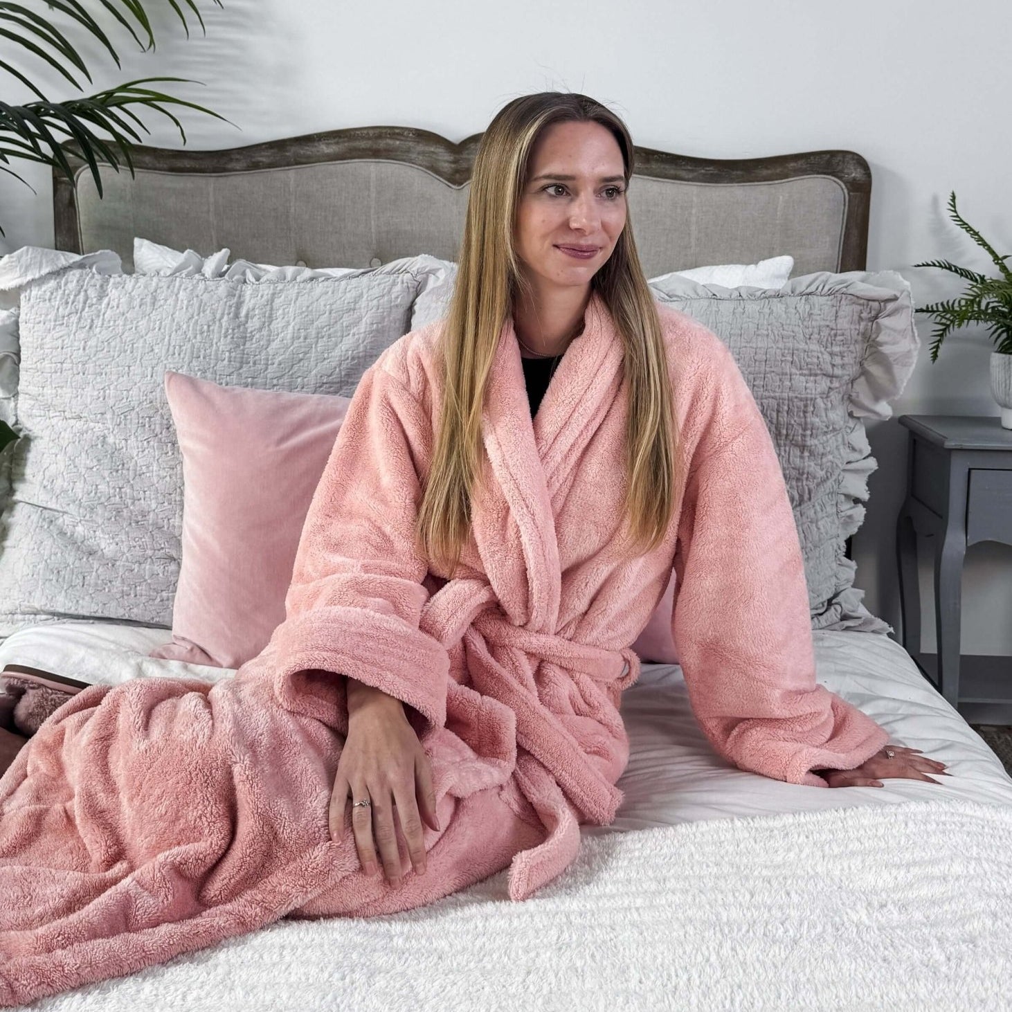 WARM BUDDY - Cozy Ultra Plush Spa Robe in Pink, Shown on a women on a bedroom setting