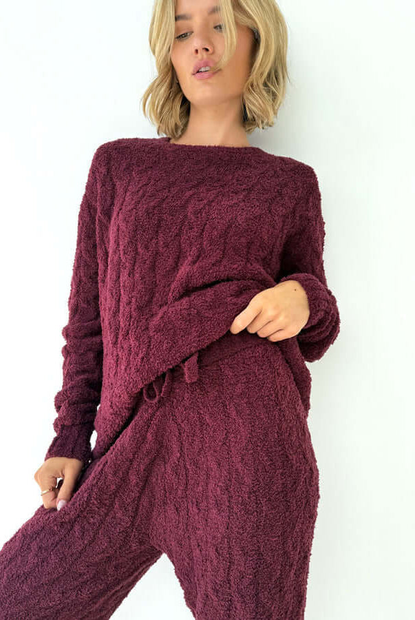Model wearing Splendid Merlot Fuzzy Cable Knit Sweater PJ Set showcasing the cozy design and comfortable fit.