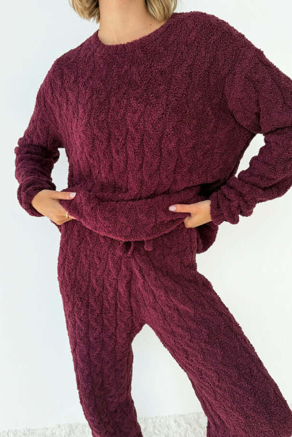 Model wearing Splendid Merlot Fuzzy Cable Knit Sweater PJ Set, showcasing cozy chenille fabric and cable knit design.