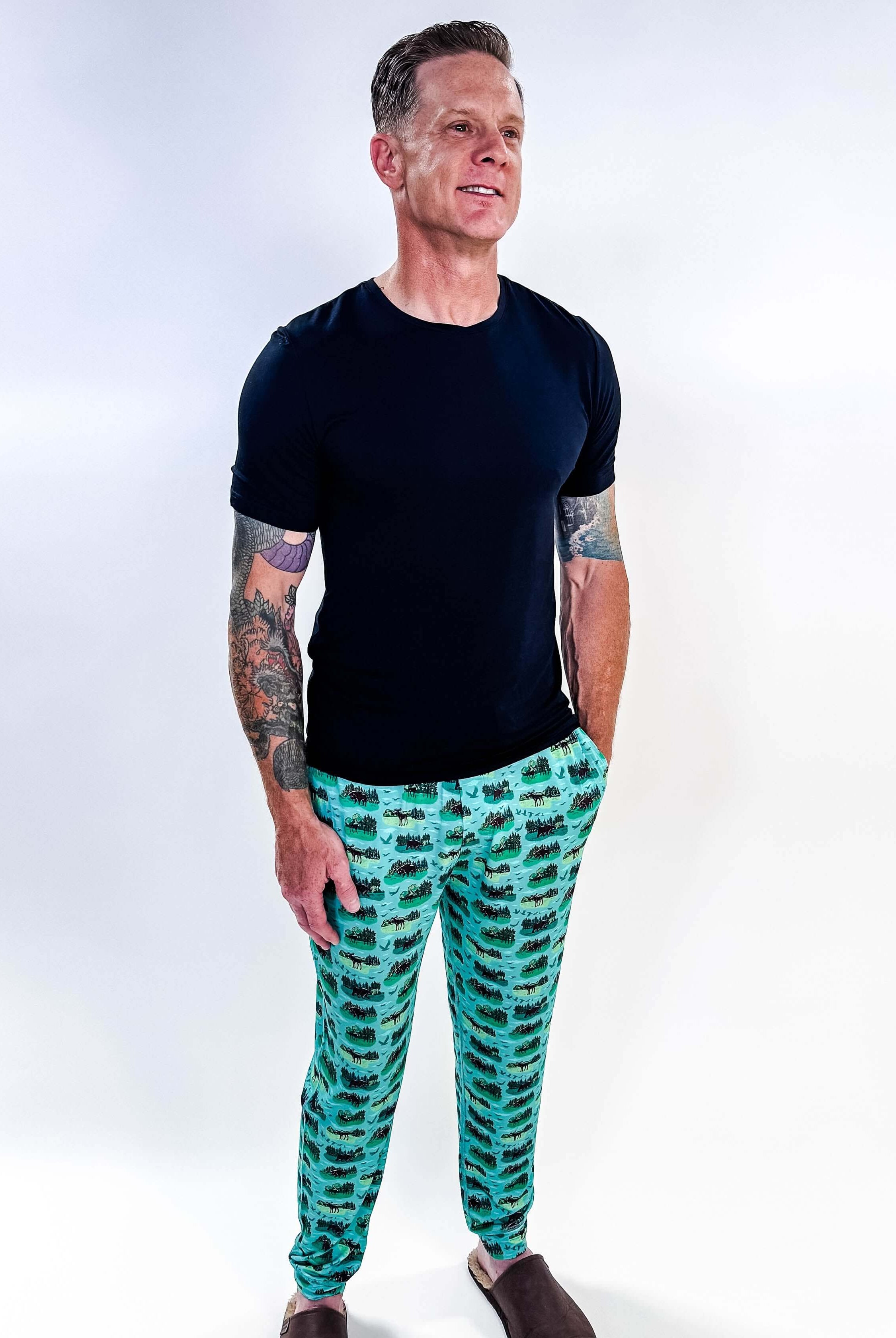 Model wearing Wildlife Aqua Unisex Bamboo Joggers with a black t-shirt, showcasing vibrant aquatic print.