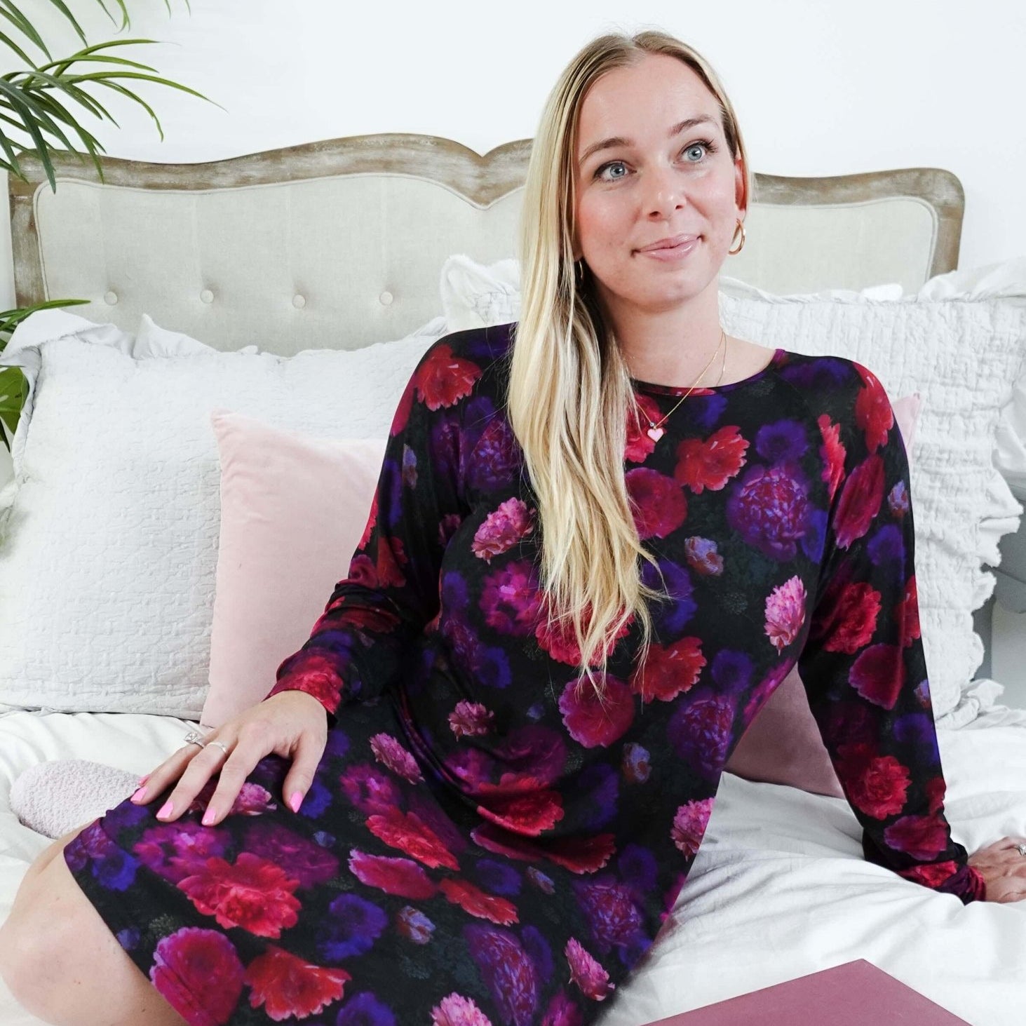 Winter Blossom Long Sleeve Bamboo Nightshirt | GEORGIA RYLAN. Model Robyn sits on a plush bed with a book in the nightgown.
