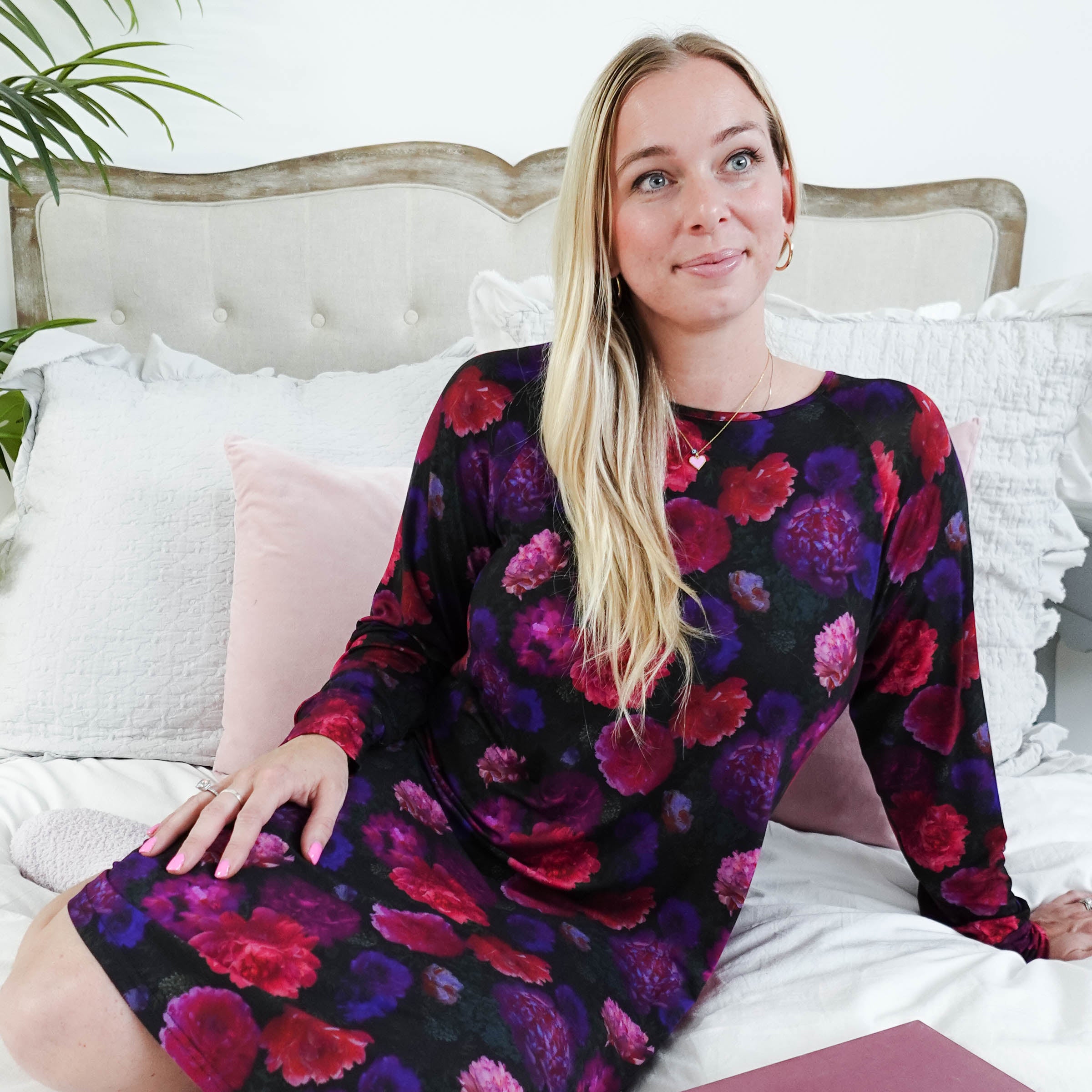 Winter Blossom Long Sleeve Bamboo Nightshirt | GEORGIA RYLAN. Model Robyn sits on a plush bed with a book in the nightgown.