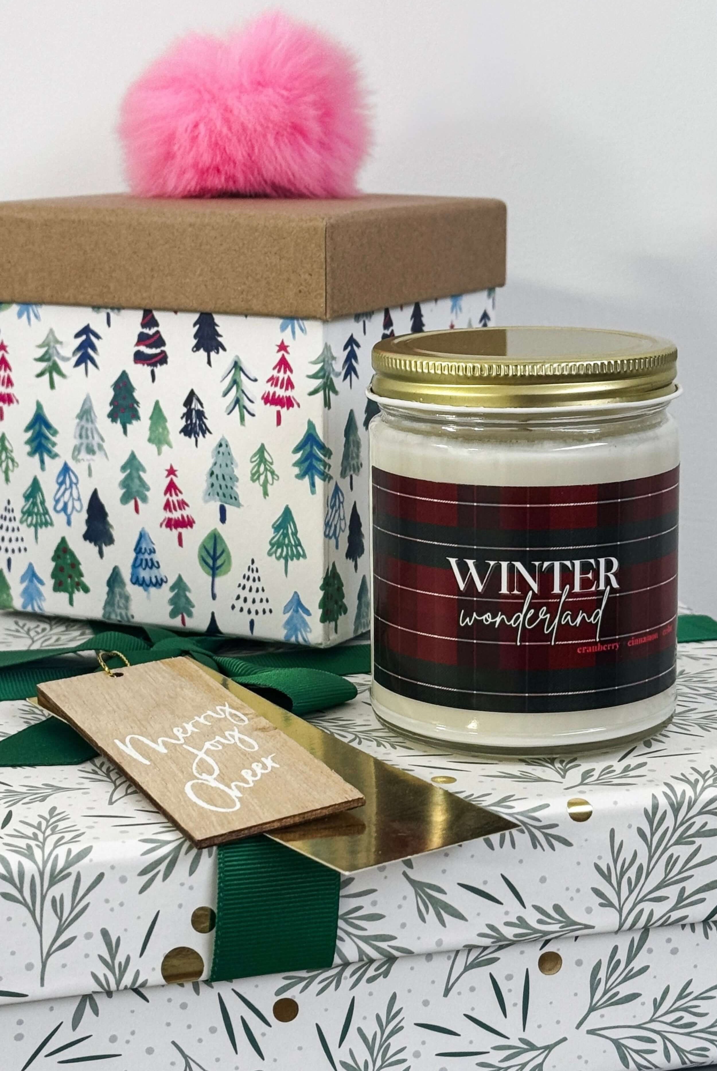 Candle labeled 'Winter Wonderland' with decorative packaging on a light gray background
