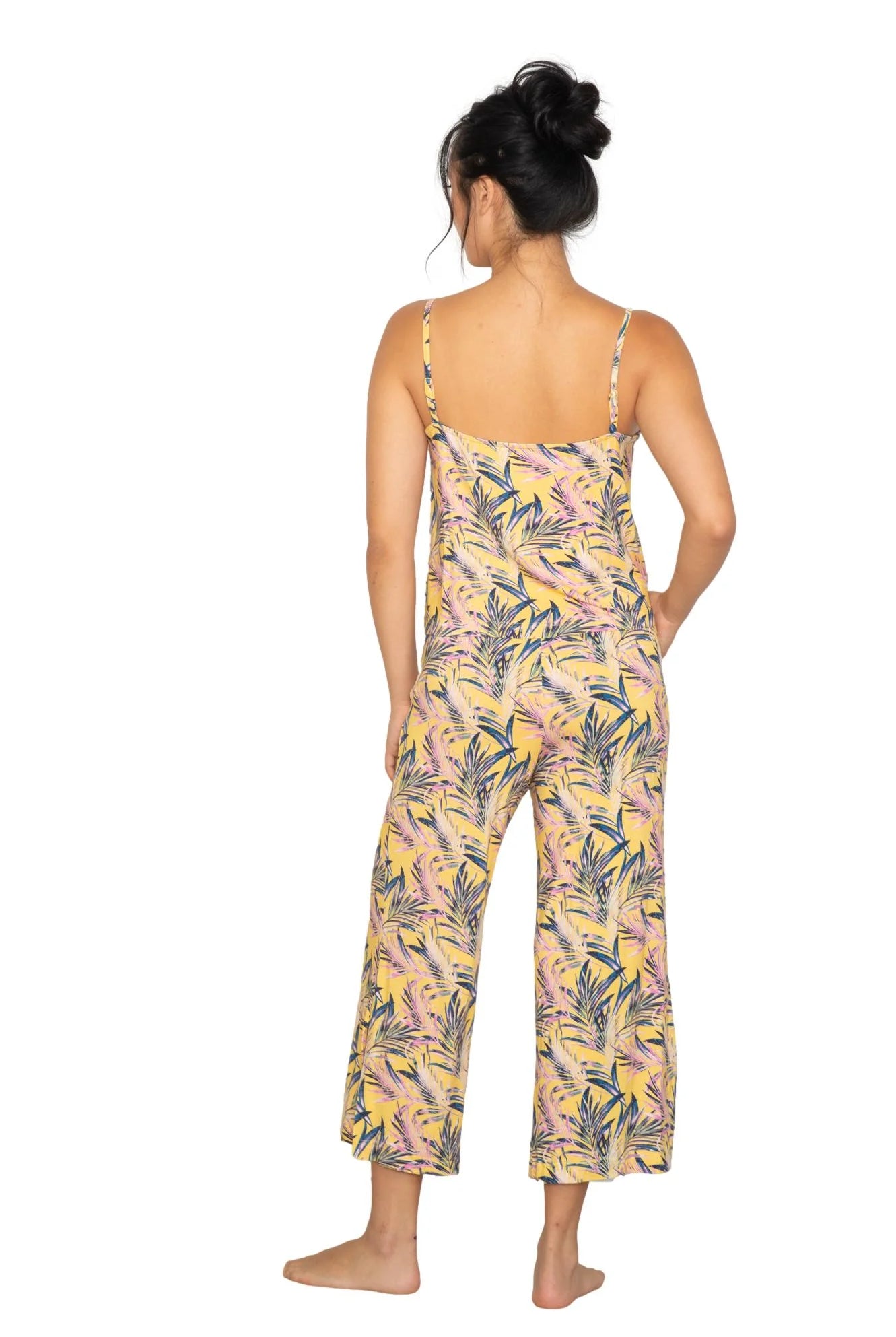 Back view of a model wearing the Cami & High Waist Capri PJ Set with a tropical print.