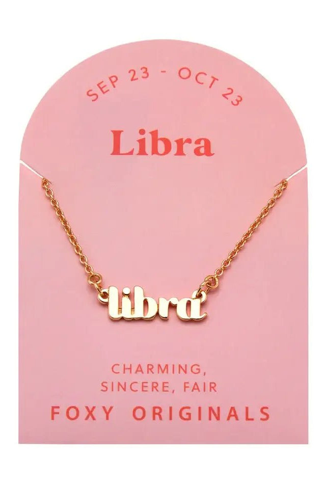 Zodiac Script Necklace in 14K Plated Gold featuring the astrological sign Libra on a pink card by Foxy Originals.