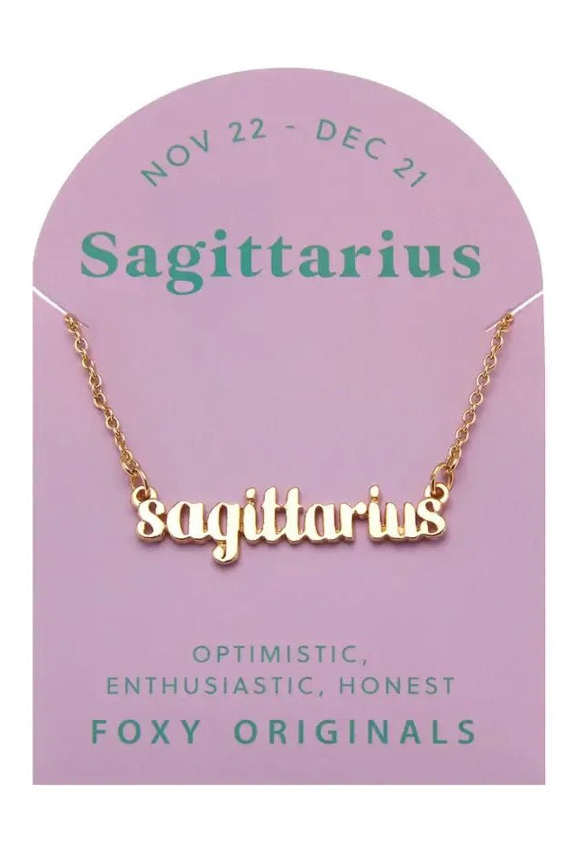 Zodiac Script Necklace in 14K Plated Gold featuring Sagittarius on a pink card, showcasing its celestial charm.