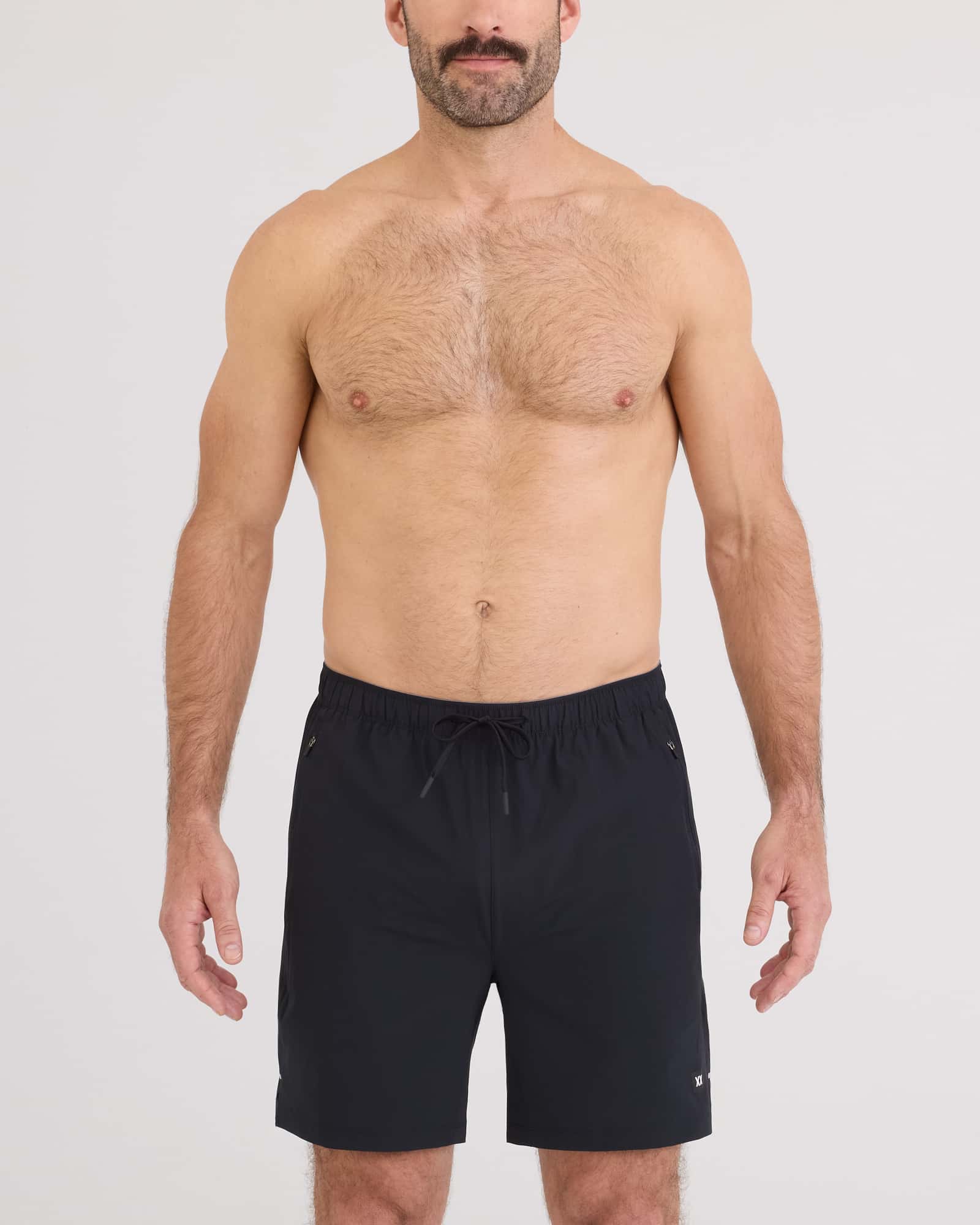 Man wearing Power Moves 2N1 Short 7 in black, showcasing comfort and performance for runners and gym enthusiasts.