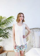 Front View  of Miranda wearing the Brunch Club velour shorts with eggs and bacon print and ivory peachy tank.
