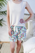 Close-up of Miranda wearing the Brunch Club velour shorts with eggs and bacon print and ivory peachy tank.