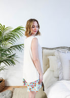 Side Profile of Miranda wearing the Brunch Club velour shorts with eggs and bacon print and ivory peachy tank.
