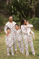 Family wearing Cali Beachy Christmas Men's Bamboo Henley Jogger Set in a tropical garden.