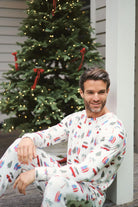 Cali Beachy Christmas Men's Bamboo Henley Jogger Set model smiling in front of a decorated Christmas tree.