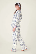 Model wearing BON VOYAGE 3-Piece Flannel PJ Set from PJ SALVAGE with a cheerful smile.