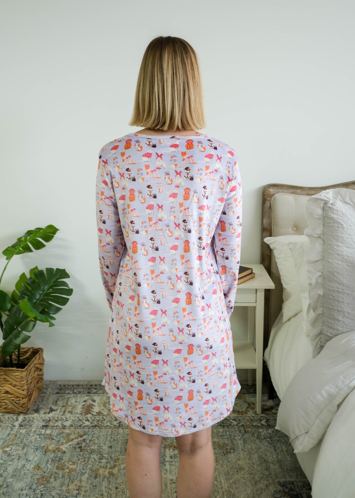 Full length back view on a model of the Miranda Nic women's purple velour long sleeve nightshirt sleep dress featuring Catwalk Kitties print - Cloud Nine Pajamas.