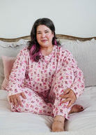 Plus size lifestyle shot on model Miranda Nic women's pink velour long sleeve top and jogger pants loungewear set featuring Chic Puppies dog print