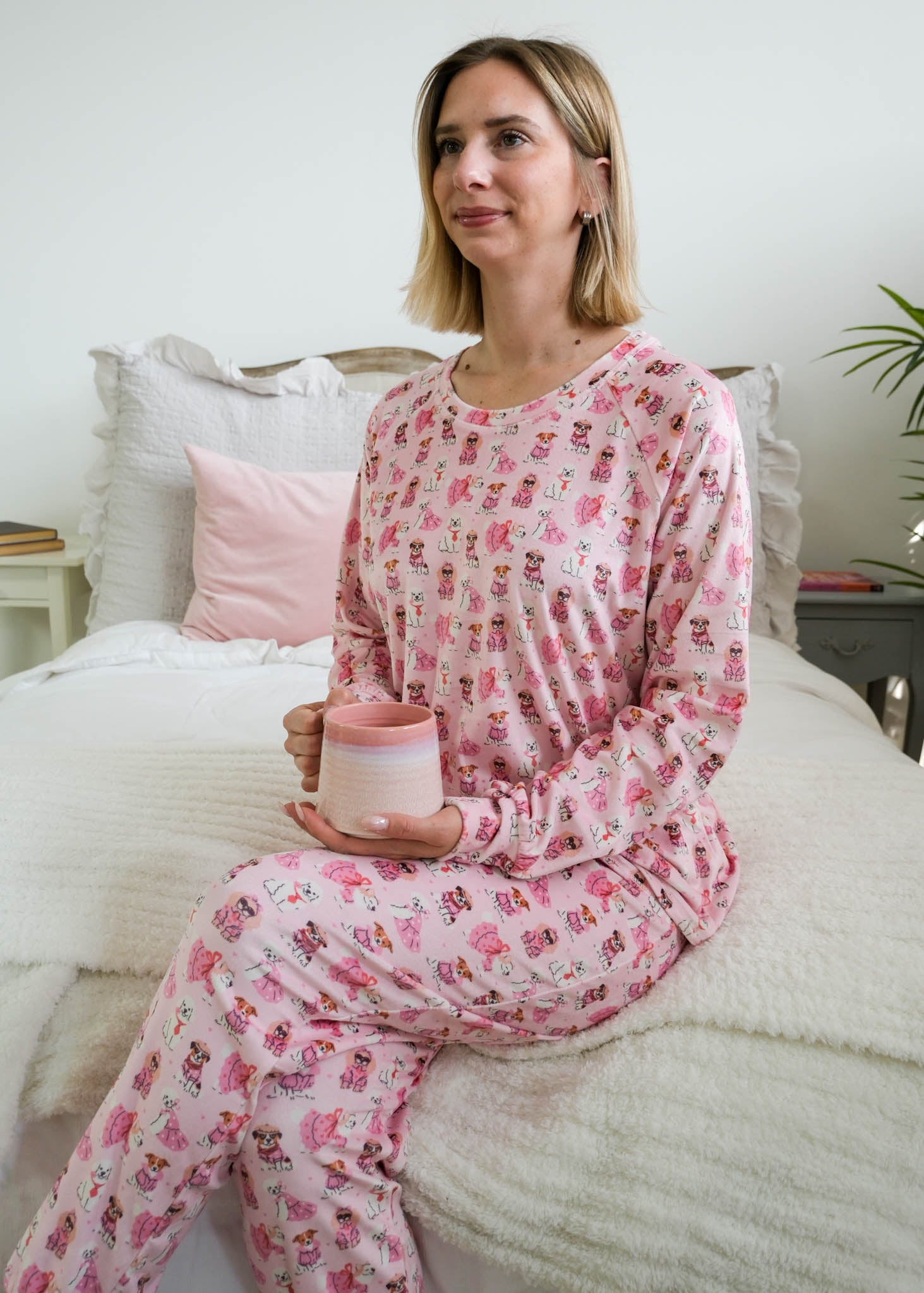lifestyle photo on model of Miranda Nic women's pink velour long sleeve top and jogger pants loungewear set featuring Chic Puppies dog print - Cloud Nine Pajamas