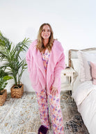 Essential Hooded Fluffy Cozy Cardigan with Pockets worn by a woman in pink, styled for comfort at home.