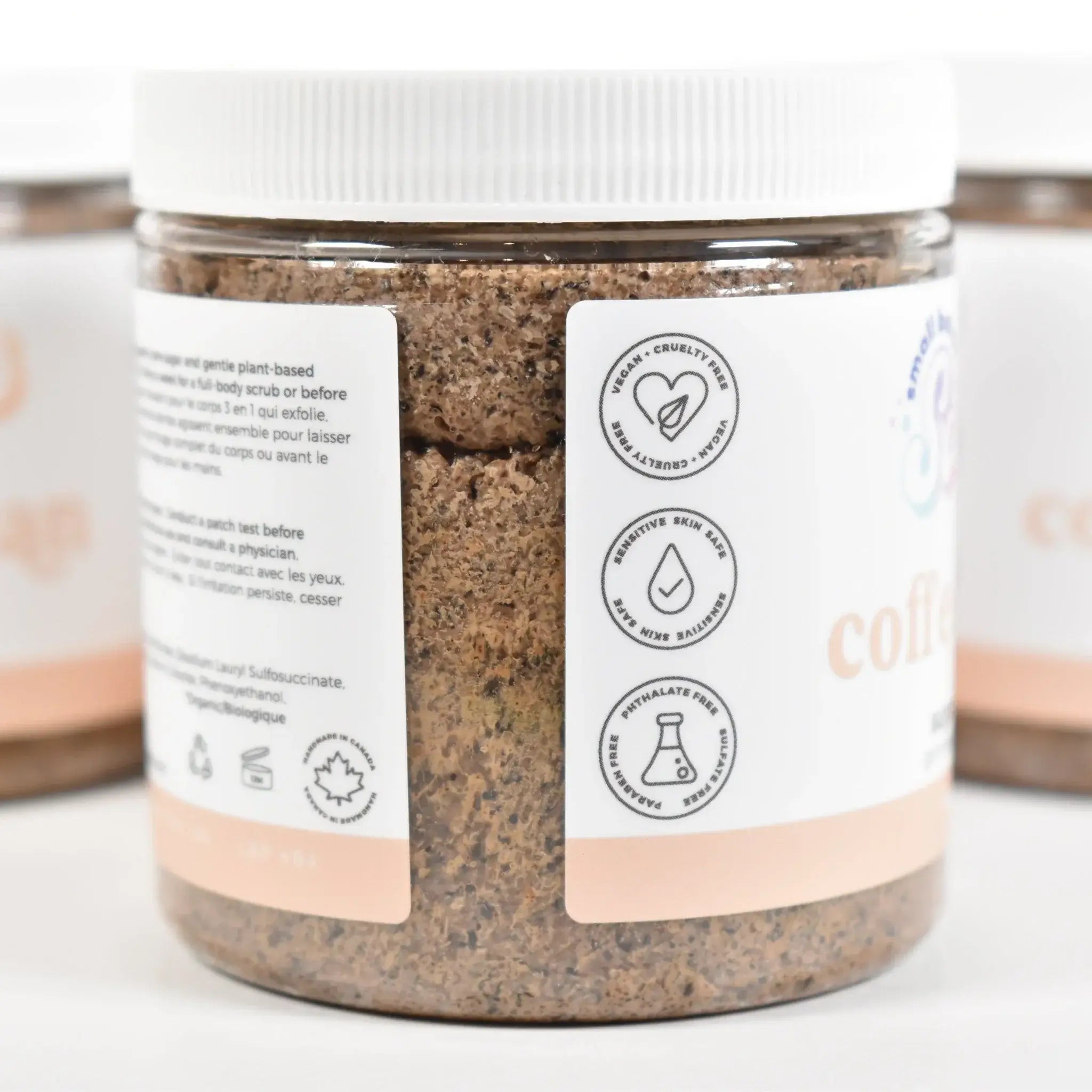 Coffee Bean Sugar Scrub jar with labels highlighting key ingredients and benefits.