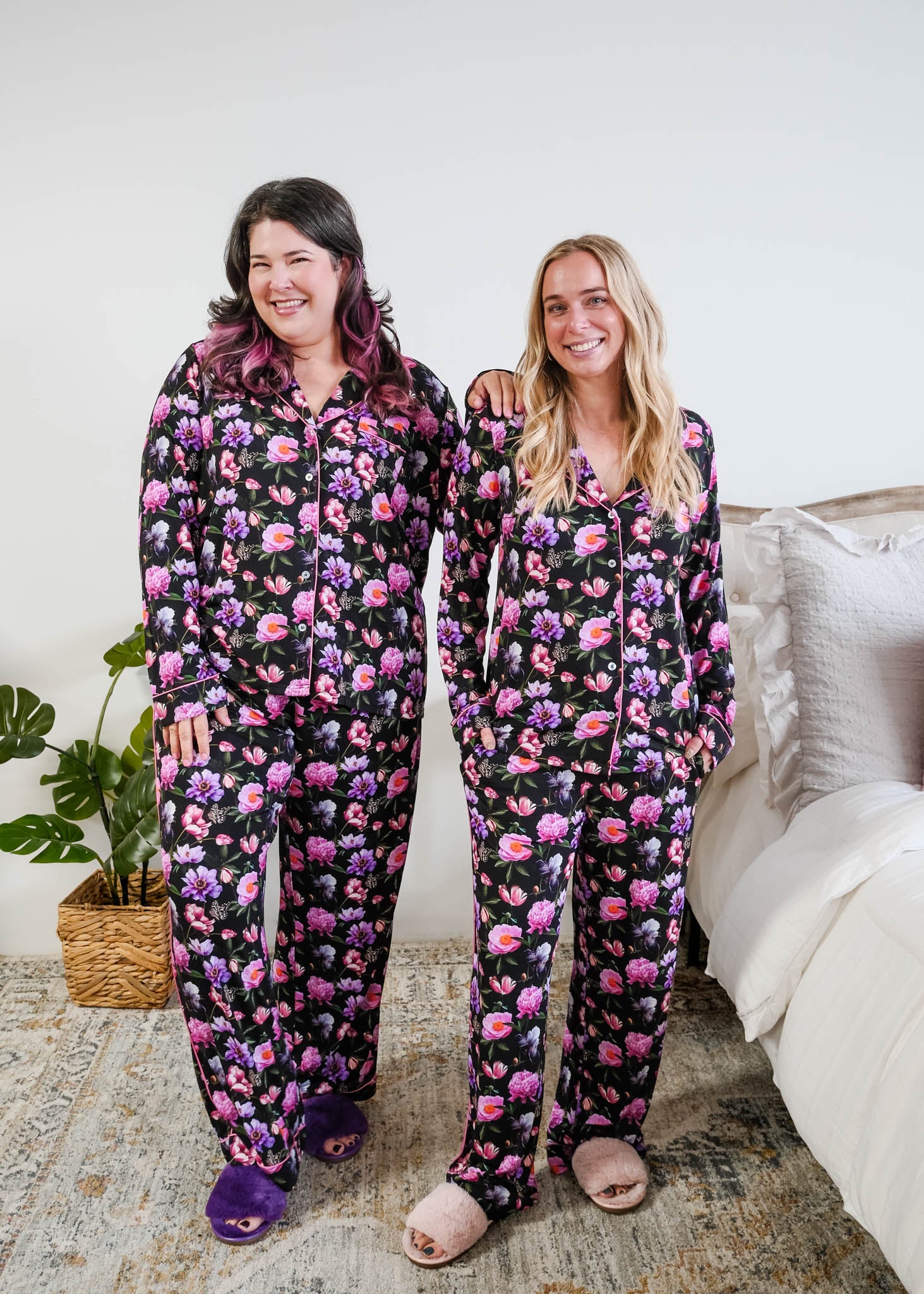Georgia Rylan women's bamboo long sleeve button-up top and straight-leg pajama pants in Dreamy Blooms black floral print - Cloud Nine Pajamas on models in a bedroom setting