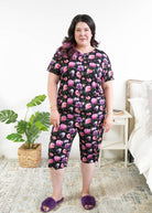 Georgia Rylan women's bamboo rolled-sleeve t-shirt and capri pajama pants in Dreamy Blooms black floral print - Cloud Nine Pajamas Plus Size Model in bedroom setting