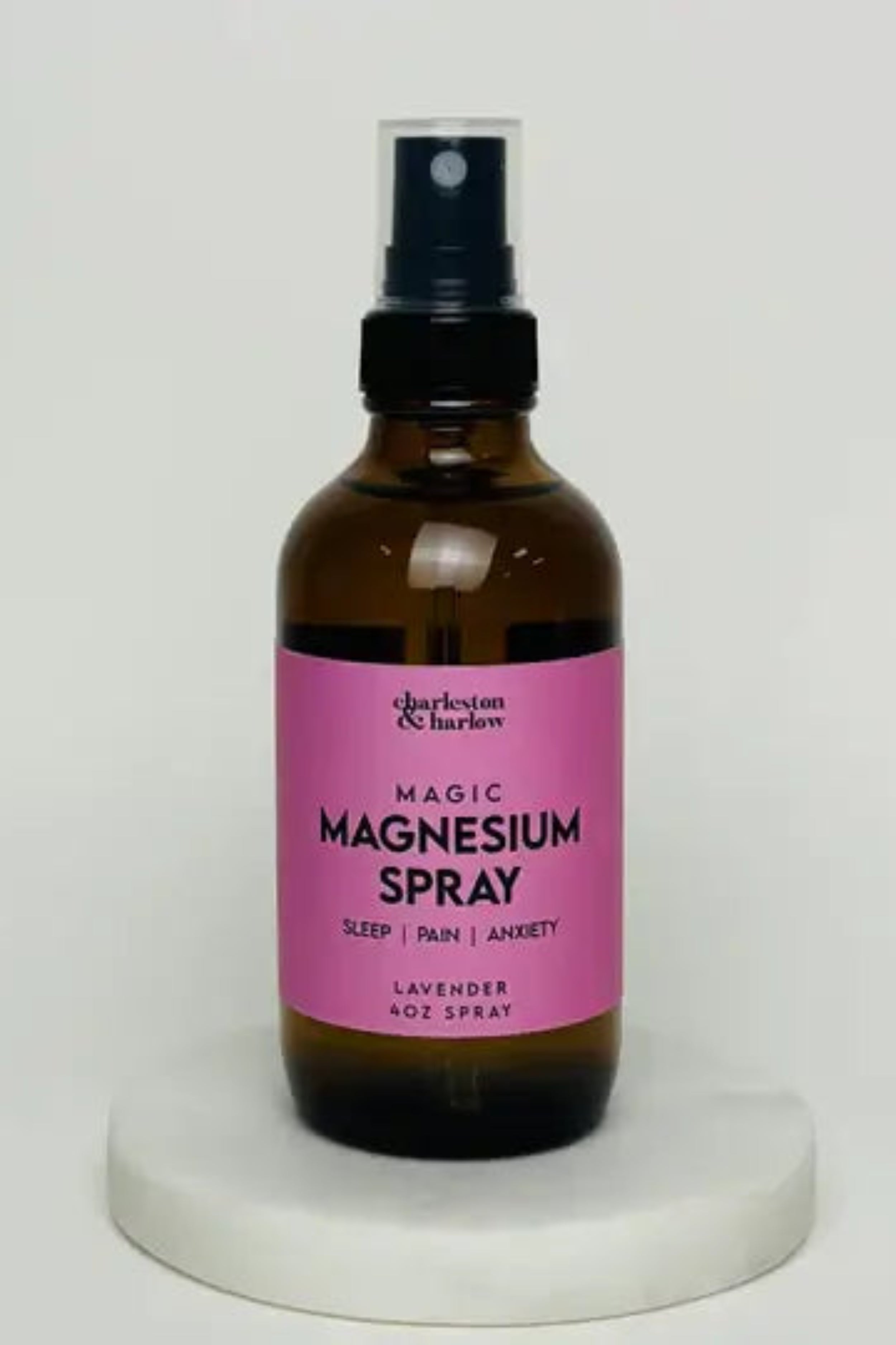all-groups Lavender Magic Magnesium Spray 4 Oz bottle on marble surface for pain relief, stress reduction, and better sleep.