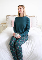 Georgia Rylan Teal Evergreen Dreams Bamboo Jogger PJ Set lifestyle seated front view — Cloud Nine Pajamas Edmonton