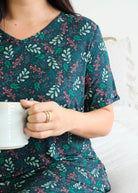 Georgia Rylan Evergreen Dreams V-Neck Bamboo Nightshirt lifestyle front view close up of green mistletoe holiday print — Cloud Nine Pajamas Edmonton