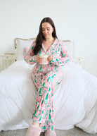 Georgia Rylan Sugar Plum Dreams Bamboo Button-Up PJ Set gingerbread print lifestyle model on bed — Cloud Nine Pajamas Edmonton