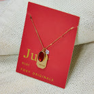Birthstone Charm Necklace in 14k Plated Gold featuring a ruby stone, labeled 'Vitality', by Foxy Originals. Birthstone Charm Necklace in 14k Plated Gold for JUNE featuring a ruby stone, labeled 'Vitality', by Foxy Originals.