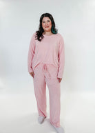 plus size woman standing wearing heather pink lounge set by miranda nic