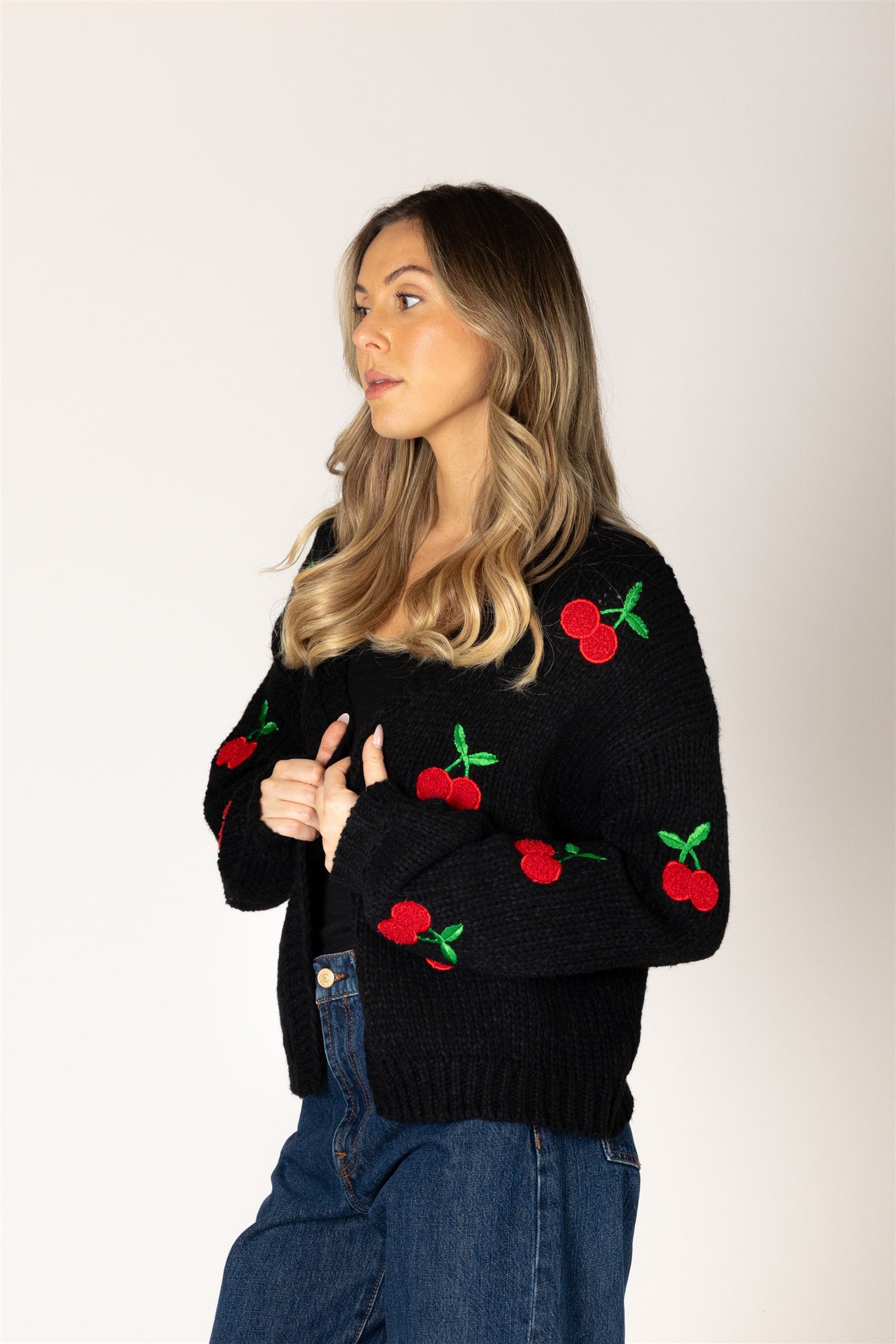 Lyla & Luxe Lexi Hand Knit Cherry Cardigan Black Red model front view — Cloud Nine Pajamas