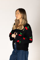 Lyla & Luxe Lexi Hand Knit Cherry Cardigan Black Red model front view — Cloud Nine Pajamas