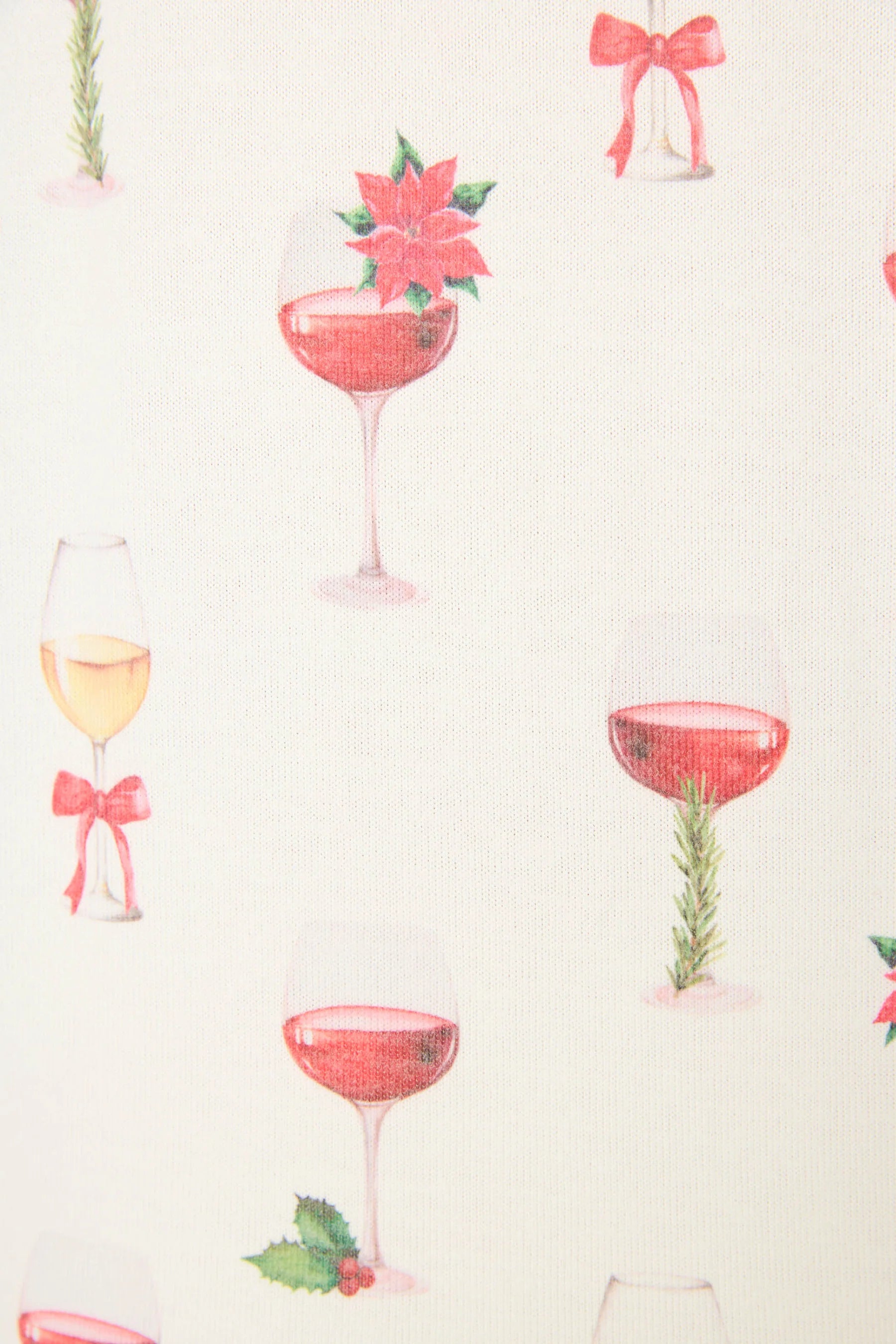 Let's Get Toasty Holiday Wine Print PJ Set | Champagne | PJ Salvage Women's set close up of print with champagne coupes with red liquid and holly, poinsettia and bows on an ivory background