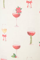 Let's Get Toasty Holiday Wine Print PJ Set | Champagne | PJ Salvage Women's set close up of print with champagne coupes with red liquid and holly, poinsettia and bows on an ivory background