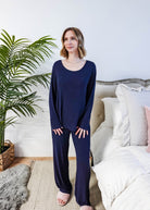 Miranda wearing the Navy Melange Top Straight Pant Knit Lounge Set, highlighting the boat-neck top and flowy trousers.
Showing shirt untucked from pants and the shape