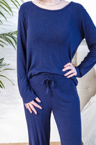 Miranda wearing the Navy Melange Top Straight Pant Knit Lounge Set, highlighting the boat-neck top and flowy trousers.
Shot showing close up of knit and mid body of the set