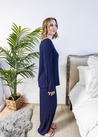 Miranda wearing the Navy Melange Top Straight Pant Knit Lounge Set, highlighting the boat-neck top and flowy trousers.
Side profile shot 