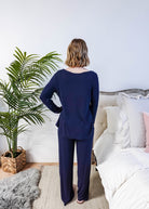 Miranda wearing the Navy Melange Top Straight Pant Knit Lounge Set, highlighting the boat-neck top and flowy trousers.
Shot showing fit from the back