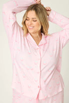 Happy Hour Wine Glass Print 3-Piece PJ Set Plus Size Inclusive model wearing playful pink pajama set with wine glass pattern, smiling.
