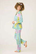 Model wearing Howdy Honey Paisley Print Flannel PJ Set from PJ Salvage, showcasing vibrant pastel colors and playful patterns.