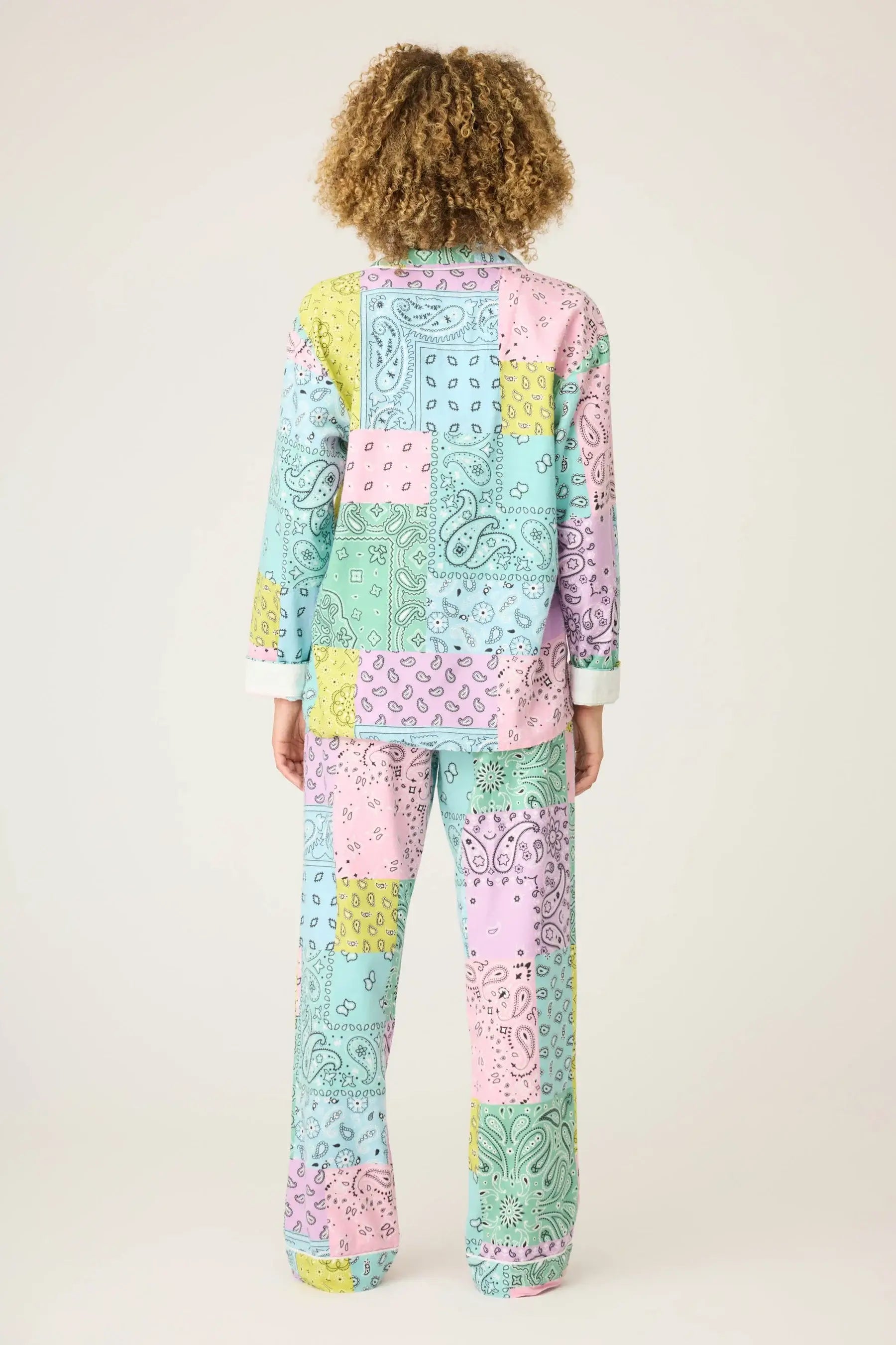 Back view of a model wearing the Howdy Honey Paisley Print Flannel PJ Set from PJ Salvage in pastel colors.