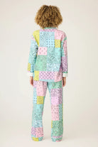 Back view of a model wearing the Howdy Honey Paisley Print Flannel PJ Set from PJ Salvage in pastel colors.