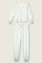 PJ Salvage Snowflake Wishes Pointelle PJ Set, showing the ivory V-neck henley top with striped cuffs and jogger pants with a pink tie in the green snowflake print.