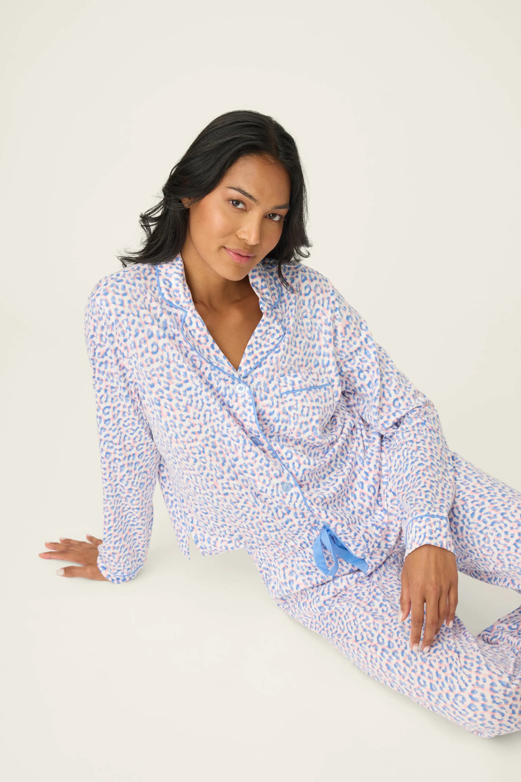 Model wearing Whimsy Walk On The Wild Side PJ Set by PJ Salvage, featuring colorful leopard print and comfortable design.