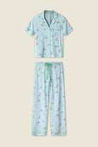 PJ SALVAGE Whimsy Cropped PJ Set in Light Blue Putter Pup print showing dogs golfing. Set shown in a lay flat against a light background