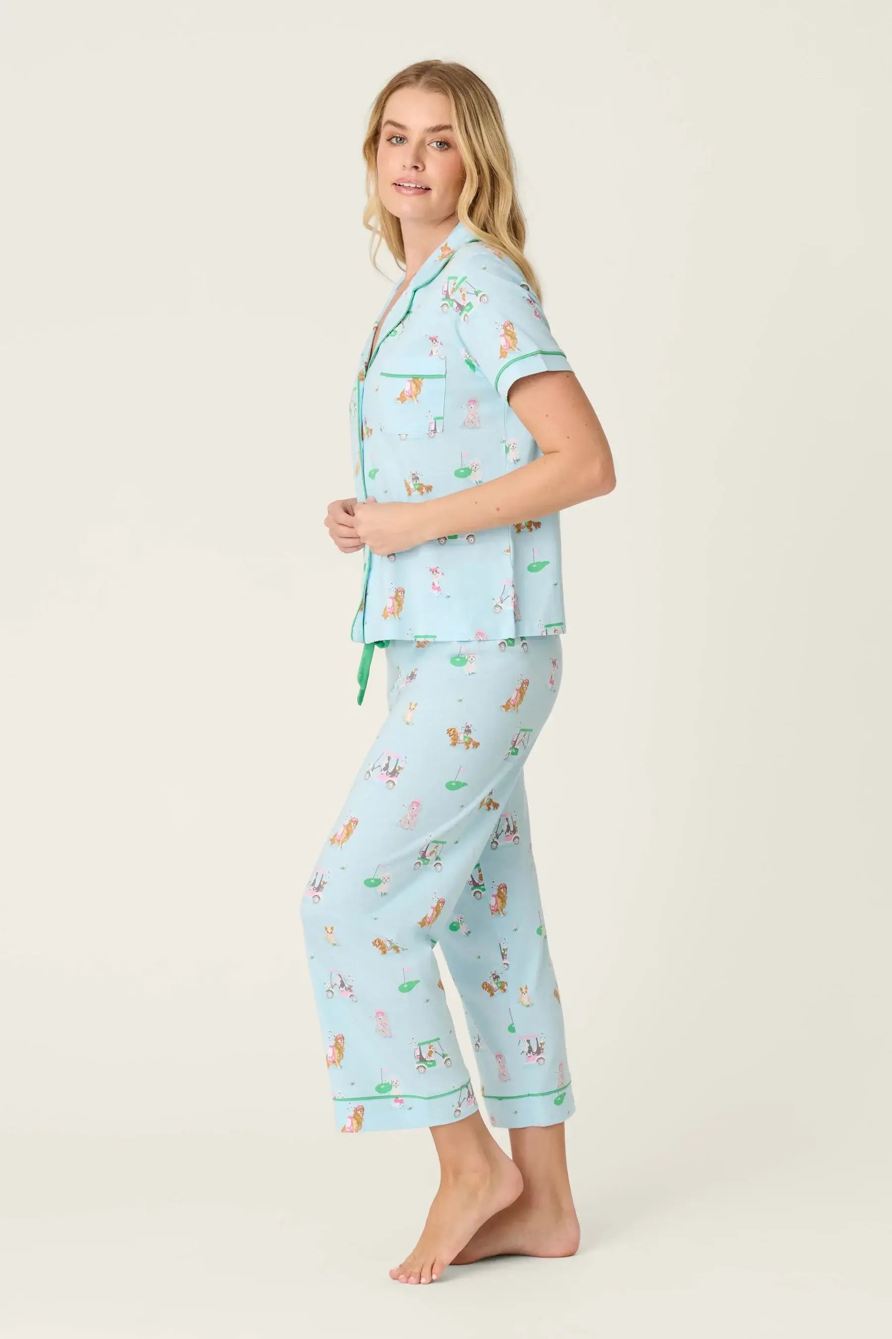 PJ SALVAGE Whimsy Cropped PJ Set in Light Blue Putter Pup print showing dogs golfing. Model stands wearing the set against a light background in a side profile showing the fit